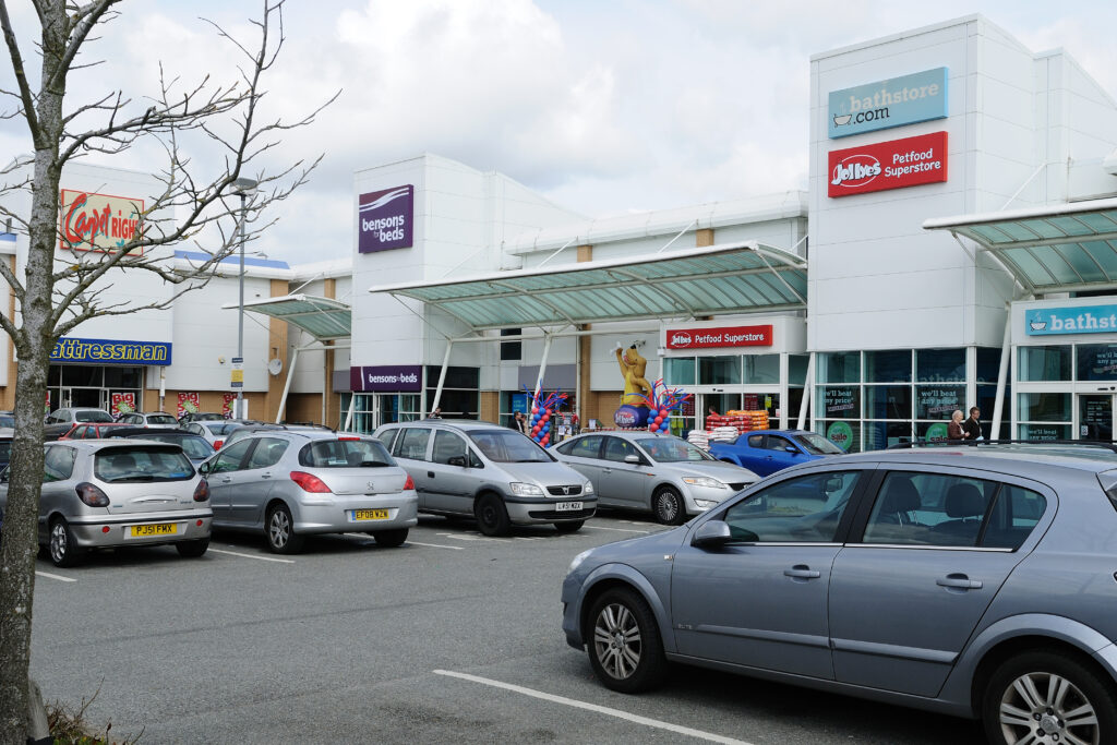 Turner Rise Retail Park units including Bensons for Beds, Jollyes and Bathstore, with parked cars
