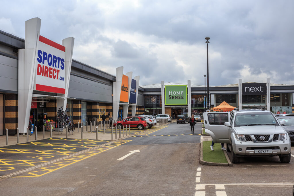 Sports Direct, Halfords, Home Sense and Next store fronts at Westside Shopping Park