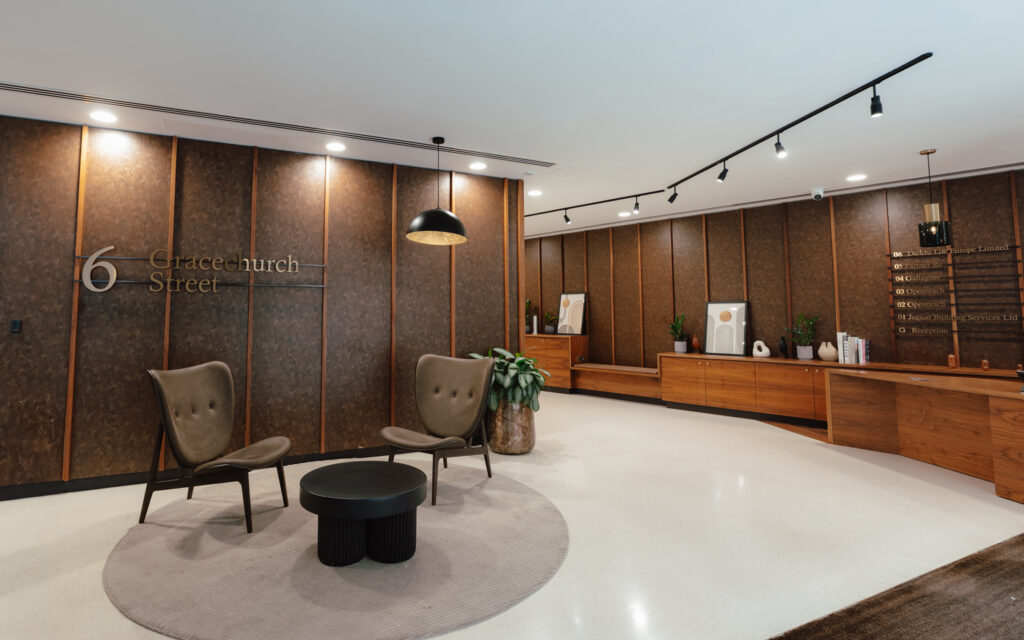 Corridor at 6 Gracechurch Street lined with timber cabinetry, artwork and planting