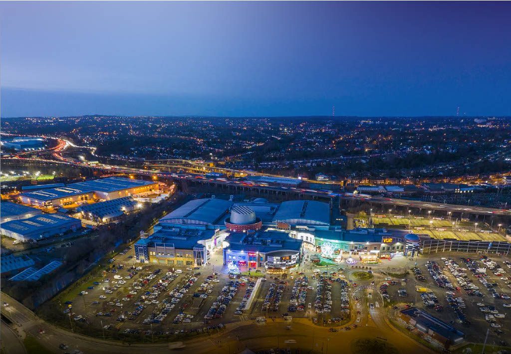 Aerial view of Star City lit up at dusk, with Birmingham beyond